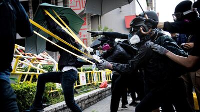 Protesters using resistance bands to shoot a slingshot of rocks or bricks. This has proven largely useful as most of the time, the protesters would keep a safe distance between them and the police. Xun Yuan for The National