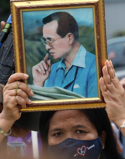 A royalist and pro-government supporter holds a photograph of the late Thai King Bhumibol Adulyadej, during a rally held to show opposition to any amendments to the constitution, in Bangkok, September 23. Narong Sangnak / EPA