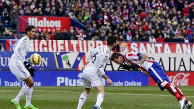 Atletico Madrid's Mario Mandzukic heads in to score his side's fourth goal in their 4-0 victory over Real Madrid in La Liga on Saturday. Dani Pozo / AFP