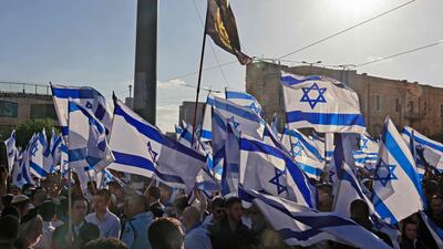 Protesters wave national flags as they march toward Jerusalem's Tzahal Square. AFP