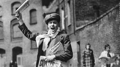 A newspaper boy with a poster calling for the conscription of all 20-year-old men in 1939