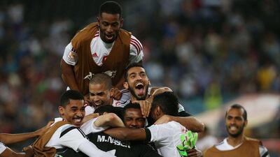 UAE players celebrate after beating Japan on penalties in their Asian Cup quarter-final match on Friday. Craig Golding / AFP