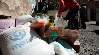 Conflict-affected people get free food rations provided by the Mona relief agency on World Food Day, in Sanaa, Yemen, in October. EPA