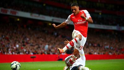 Danny Rose of Tottenham Hotspur tackles Alex Oxlade-Chamberlain of Arsenal during their 1-1 draw on Saturday at the Emirates Stadium. Paul Gilham / Getty Images