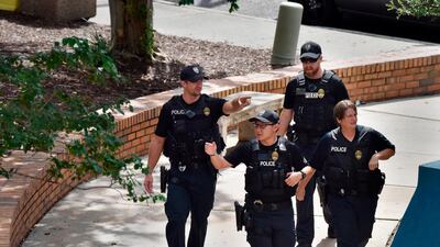 Police investigate the scene of a multiple shooting at the Jacksonville Landing. AP Photo