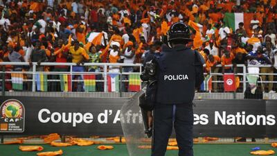 Police stand guard in front of Ivory Coast’s fans celebrating after the team won their semi-final soccer match of the 2015 African Cup of Nations against Democratic Republic of Congo in Bata, February 4, 2015. Goals from Yaya Toure and Gervinho helped steer Ivory Coast into the African Nations Cup final in a 3-1 win over Democratic Republic of Congo in the Estadio de Bata on Wednesday. REUTERS/Amr Abdallah Dalsh