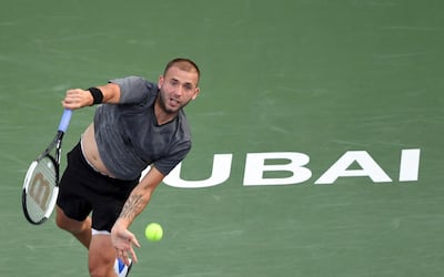 Britain's Daniel Evans serves the ball to Italy's Fabio Fognini during the Dubai Duty Free Tennis Championships in the United Arab Emirates on February 25, 2020. / AFP / KARIM SAHIB
