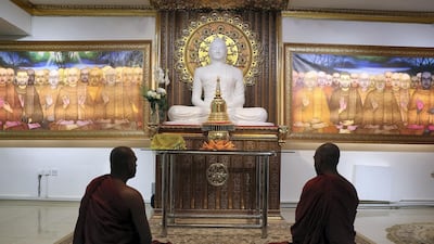 Two Buddhist priests meditate at the temple in Jumeirah. Chris Whiteoak / The National