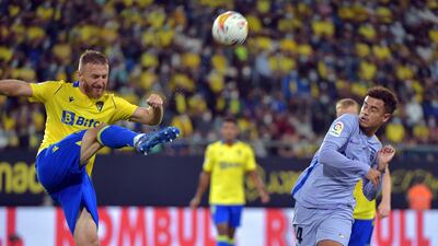 Cadiz defender Varazdat Haroyan kicks the ball next to Barcelona midfielder Philippe Coutinho. AFP