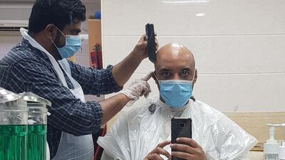 Barber Zein Abideen gives Saeed Saeed his long overdue haircut. Courtesy Saeed Saeed
