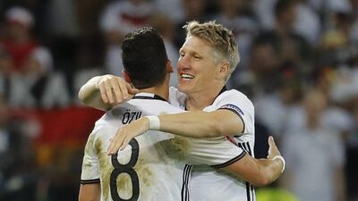 Bastian Schweinsteiger celebrates his late goal with Mesut Ozil during Germany's victory over Ukraine. Pascal Rossignol / Reuters
