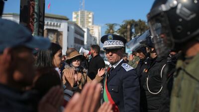 Security forces stand guard as Moroccan teachers stage a protest calling to improve wages and promotion opportunities, in Rabat, Morocco. AP Photo