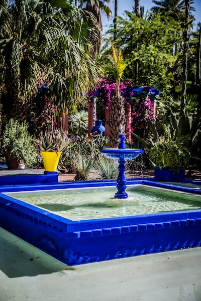 Visual elements, such as water fountains, can break things up if growing lush greenery is a challenge. Getty Images