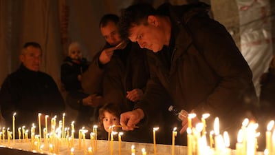 People light candles during a gathering to commemorate Kosovo Serb leader Oliver Ivanovic, in Saint Sava church in Belgrade. Igor Pavicevic / Reuters