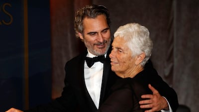 Best Actor Joaquin Phoenix embraces his mother Arlyn Phoenix as his Best Actor award is engraved at the Governors Ball after the Oscars on Sunday, February 9, 2020, at the Dolby Theatre in Los Angeles. Reuters