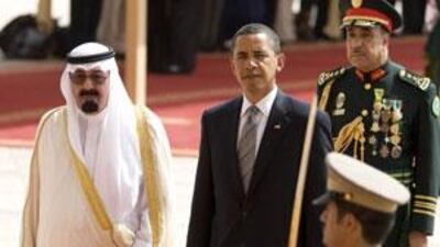 The US president Barack Obama (centre) is welcomed to the Kingdom of Saudi Arabia by King Abdullah (left) at King Khalid International Airport in Riyadh.