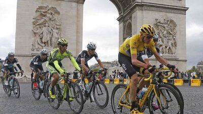 Team Sky rider Chris Froome of Britain, right, the race leader's yellow jersey, cycles near the Arc de Triomphe during the 109.5-km (68 miles) final stage of the Tour de France from Sevres to Paris Champs-Elysees, France, July 26, 2015. REUTERS/Pascal Rossignol