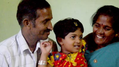 Kusuma after corrective surgery to repair a congenital heart defect, with her parents. Courtesy Burjeel Hospital