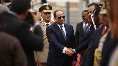 Egyptian President Abdel-Fattah Al Sisi shakes hands with Sudanese officials as he is received by his Sudanese counterpart at Khartoum International Airport outside the Sudanese capital. AFP