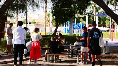 Participants take a rest at Al Khazzan Park.