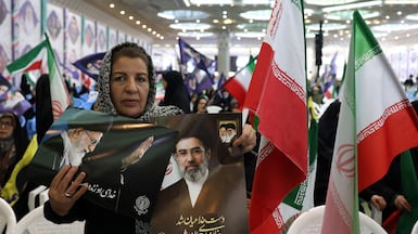 An Iranian woman holds a portrait of supreme leader Ayatollah Mojtaba Khamenei at a ceremony in Tehran. EPA