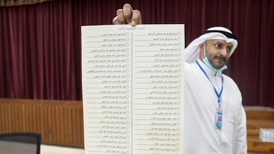 A Kuwaiti official holds the ballot for the 2nd constituency at a polling station during parliamentary elections in Kuwait City, Kuwait. Reuters