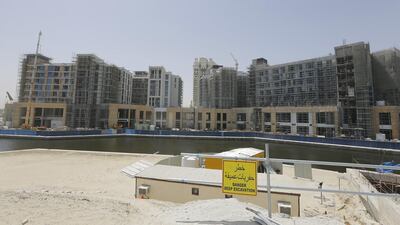 In the UAE, real estate investment trusts are increasingly considered an attractive prospect for individual investors. Jeffrey E Biteng / The National