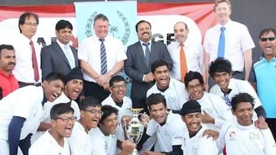David East, chief executive of Emirates Cricket Board, fourth from left, poses with The Cambridge High School. East has reiterated schools cricket is crucial to the development of the game. Amith Passela / The National