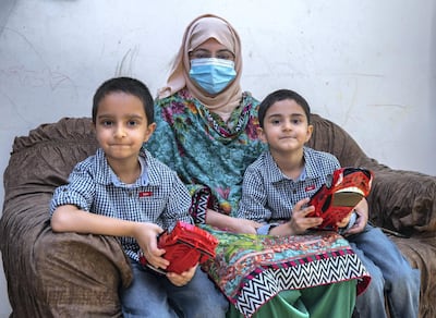 Alia Usman, widow of Muhammad Usman Khan, who died of Covid-19, with her sons Mohanad, 6, left, and Akhdan, 5. Victor Besa / The National