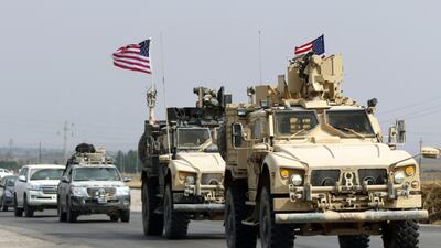 A convoy of US military vehicles arrives near the Iraqi Kurdish town of Bardarash in the Dohuk governorate after withdrawing from northern Syria on October 21, 2019. / AFP / SAFIN HAMED
