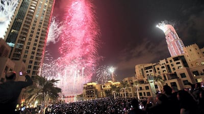 Fireworks illuminate Burj Khalifa while thousands of people gather to celebrate the New Year at midnight in Dubai on January 1, 2013. AFP PHOTO