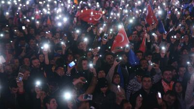 Supporters of Turkey’s ruling AK party (AKP) cheer as they follow the election’s results in front of the party’s headquarters in Ankara. Adem Altan / AFP