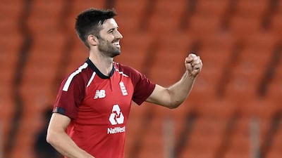 England's Mark Wood celebrates the dismissal of India opener Rohit Sharma for 15. AFP
