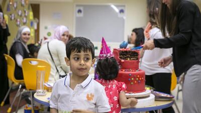 A pupil at the New England Centre for Children celebrates his sixth birthday. The centre in Mohammed bin Zayed City, Abu Dhabi, says demand is so high that it will add two classrooms next year, with room for 14 more autistic children. Silvia Razgova / The National