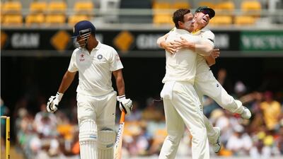 Josh Hazlewood, right, of Australia celebrates with teammate David Warner after dismissing MS Dhoni of India for LBW during Day 4 of the seond Test match at The Gabba on December 20, 2014 in Brisbane, Australia. (Photo by Cameron Spencer/Getty Images)