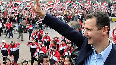Bashar Al Assad, the Syrian president, waves to supporters during a rare public appearance in Damascus yesterday.