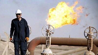 A worker at the West Qurna oilfield in Basra, Iraq. The country's plans to become one of the world's top oil producers is being jeopardised by the lack of a legal framework. Atef Hassan / Reuters