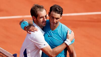 Rafael Nadal, right, embraces Richard Gasquet at the net following their French Open third round match on Saturday. Ian Langsdon / EPA
