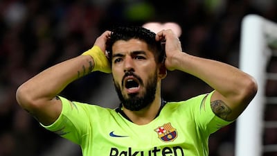 In this file photo taken on April 10, 2019 Barcelona's Uruguayan forward Luis Suarez reacts to missing a shot on goal during the Champions League match against Manchester United at Old Trafford. Atletico Madrid announced the signing of Suarez late on Wednesday. AFP