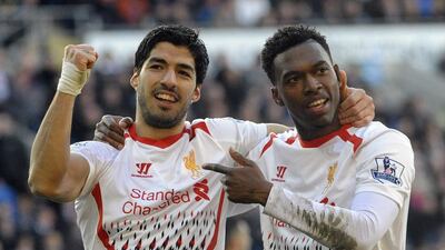 Liverpool's Daniel Sturridge, right, celebrates scoring a goal with Luis Suarez during their English Premier League match against Cardiff City in Cardiff, Wales, March 22, 2014. Rebecca Naden / Reuters