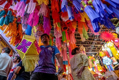 People browse colourful lanterns for sale at a local market for Diwali in Mumbai. EPA