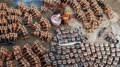 An Indian potter prepares clay lanterns used during Diwali celebrations ahead of the forthcoming Hindu festival in Jalandhar. Shammi Mehdra / AFP