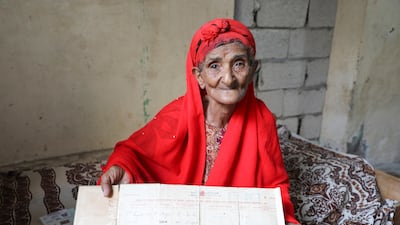 Kulthoom Muhammad Saeed, 80, shows her birth certificate as she talks to Reuters at her home about memories of the Queen Elizabeth's visit to Aden in 1954 during the period that Aden was a colony within the British Empire, in Aden,Yemen September 11, 2022. REUTERS / Fawaz Salman