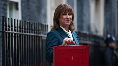 Britain's Chancellor of the Exchequer Rachel Reeves poses with the red budget briefcase outside her office in Downing Street, London. Reuters