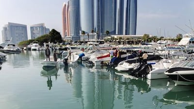 This four-metre-long whale shark drew onlookers at the marina near the InterContinental hotel in Abu Dhabi. Coastguards tried to redirect it to the exit. Irene García León for The National