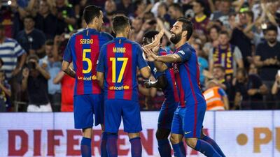 Barcelona´s Arda Turan (R) celebrates after scoring against Sevilla FC during the Spanish Super Cup second leg match between FC Barcelona and Sevilla FC played at Camp Nou stadium in Barcelona, Spain, 17 August 2016. Quique García / EPA