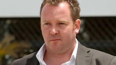 Vince Acors from Britain, whose female counterpart is not shown, exits the Dubai Courts, Dubai.