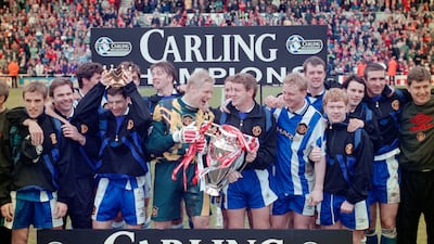Steve Bruce and goalkeeper Peter Schmeichel celebrate with the 1995-96 Premiership trophy after winning the title with 82 points. Getty