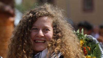 epa06917620 Ahed Tamimi, a 17-year-old Palestinian campaigner against Israel's occupation, looks on after arrival at her village Nabi Salih, near the West Bank town of Ramallah, 29 July 2018. Ahed Tamimi, who was arrested last December after she was filmed slapping an Israeli soldier near Ramallah, in the occupied West Bank, was released on the day from prison after serving nearly eight-month in detention. EPA/ALAA BADARNEH