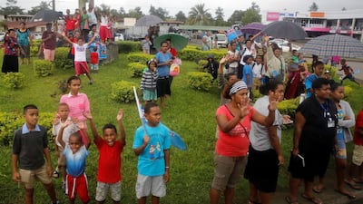 Well-wishers stand along the streets. Reuters